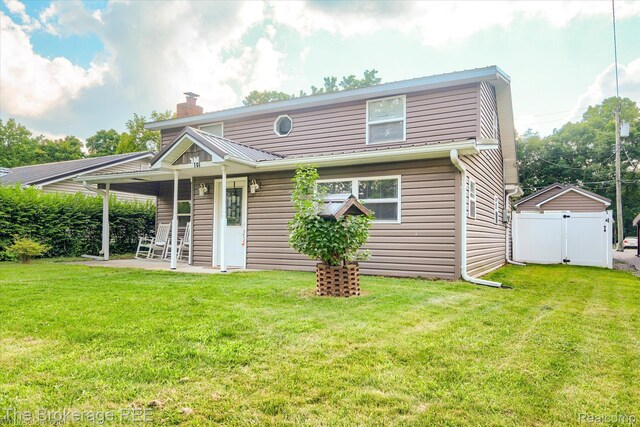 166 Indian Trl, Columbiaville, MI 48421 - view of front of home featuring a chimney, a patio area, and a gate