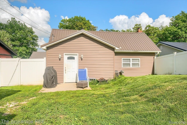 166 Indian Trl, Columbiaville, MI 48421 - back of property featuring a metal roof and a chimney
