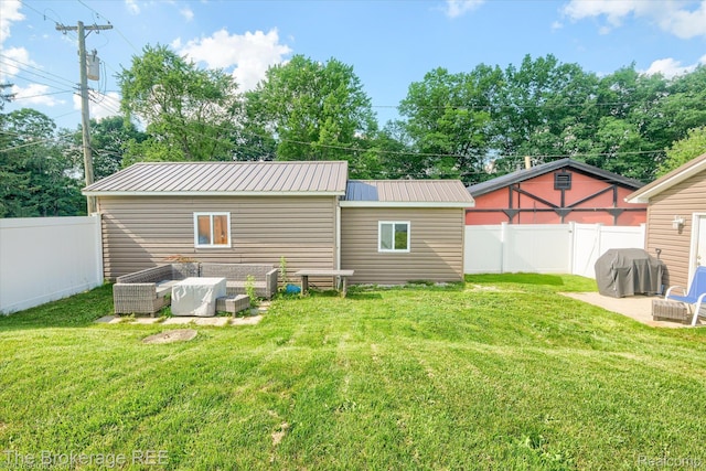166 Indian Trl, Columbiaville, MI 48421 - back of house featuring a metal roof and a fenced backyard