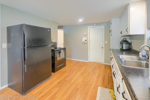 166 Indian Trl, Columbiaville, MI 48421 - kitchen featuring black appliances, dark countertops, white cabinets, light wood-type flooring, and recessed lighting