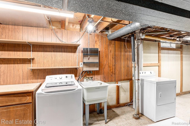 3408 Ardmore Dr, Troy, MI 48083 - laundry area featuring washer and clothes dryer, wooden walls, and light floors