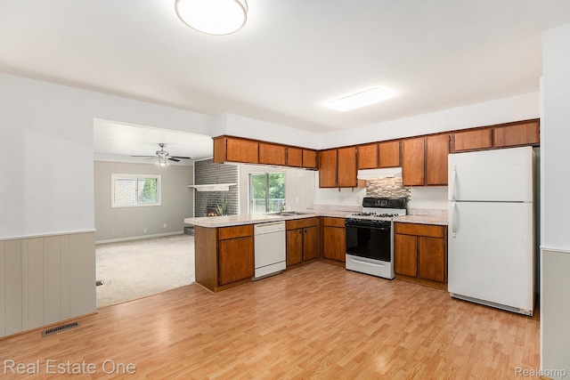 3408 Ardmore Dr, Troy, MI 48083 - kitchen featuring white appliances, under cabinet range hood, brown cabinets, and light wood-style floors