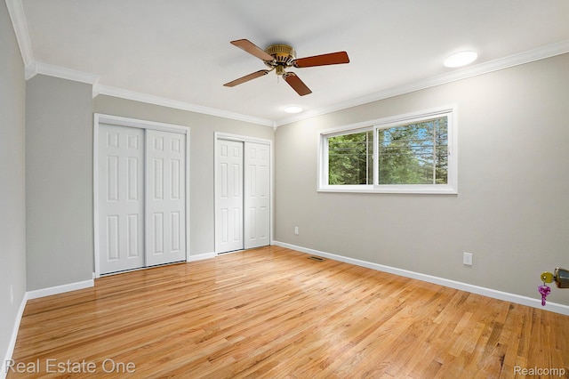 3408 Ardmore Dr, Troy, MI 48083 - unfurnished bedroom with multiple closets, ornamental molding, light wood finished floors, and a ceiling fan