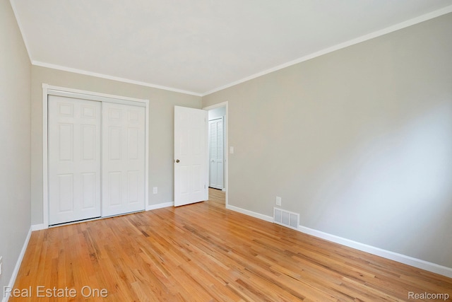 3408 Ardmore Dr, Troy, MI 48083 - unfurnished bedroom with light wood finished floors, a closet, and ornamental molding