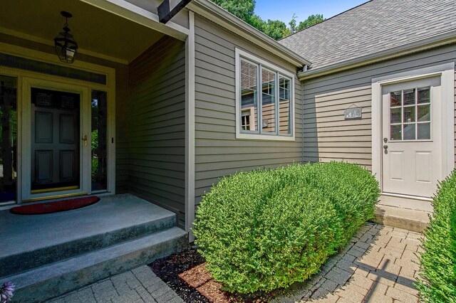 2736 Aspen Ct, Ann Arbor, MI 48108 - doorway to property featuring a shingled roof