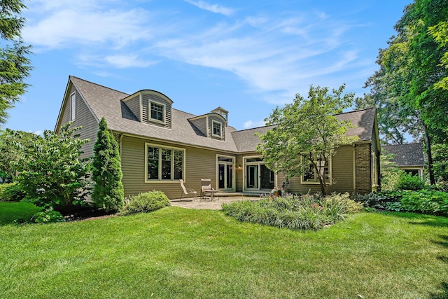 2736 Aspen Ct, Ann Arbor, MI 48108 - back of property with a yard, a patio, and roof with shingles