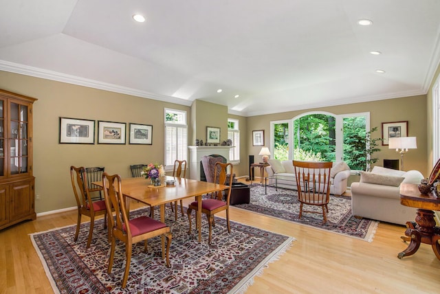 2736 Aspen Ct, Ann Arbor, MI 48108 - dining room featuring lofted ceiling, healthy amount of natural light, ornamental molding, light wood-type flooring, and a fireplace