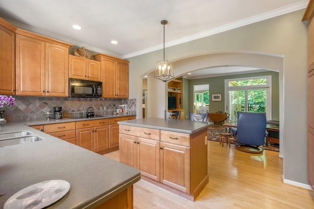 2736 Aspen Ct, Ann Arbor, MI 48108 - kitchen featuring black microwave, arched walkways, a center island, backsplash, and light wood-style flooring