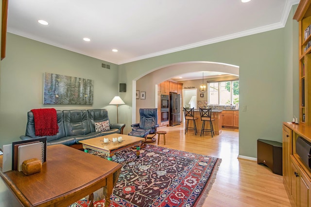 2736 Aspen Ct, Ann Arbor, MI 48108 - living area with arched walkways, light wood-style flooring, crown molding, and recessed lighting