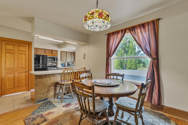2050 S Wagner Rd, Ann Arbor, MI 48103 - dining area with light tile patterned flooring