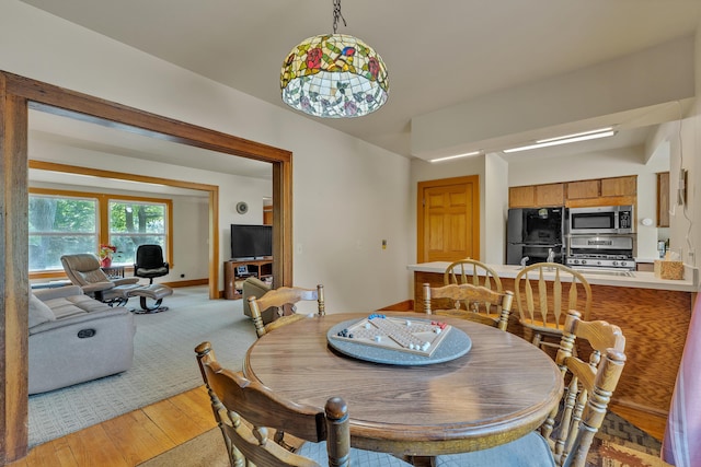 2050 S Wagner Rd, Ann Arbor, MI 48103 - dining room with light wood-style floors and baseboards
