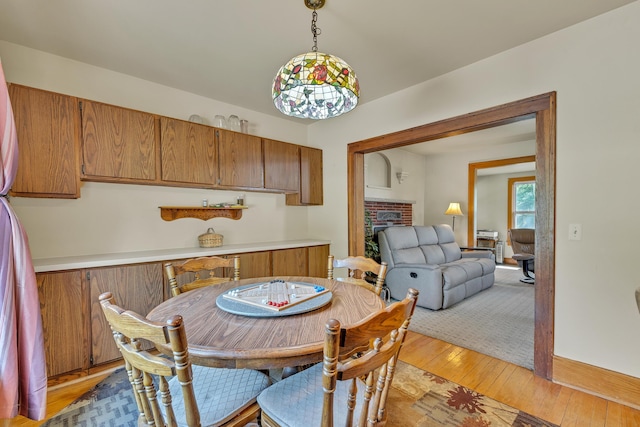 2050 S Wagner Rd, Ann Arbor, MI 48103 - dining area featuring a brick fireplace and light wood-style flooring
