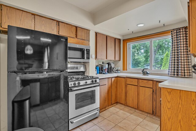2050 S Wagner Rd, Ann Arbor, MI 48103 - kitchen with stainless steel appliances, light countertops, and light tile patterned floors
