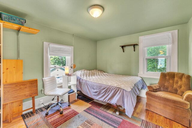 2050 S Wagner Rd, Ann Arbor, MI 48103 - bedroom featuring wood finished floors and baseboards