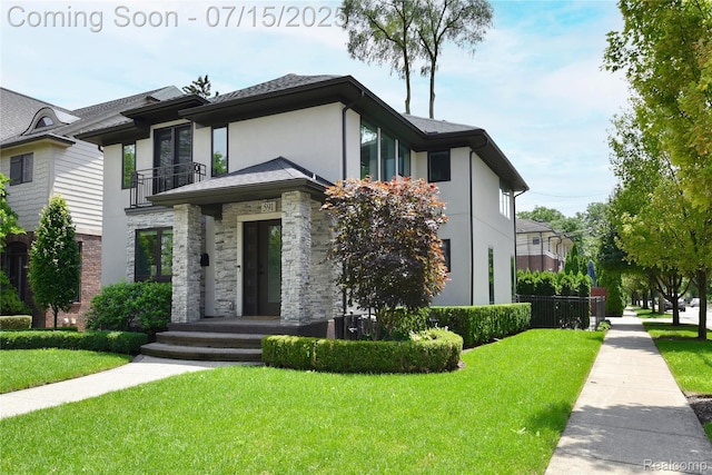 591 Wallace St, Birmingham, MI 48009 - view of front of home with stucco siding, a front yard, a balcony, and stone siding