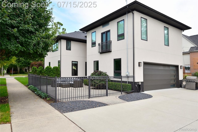 591 Wallace St, Birmingham, MI 48009 - contemporary home featuring stucco siding, concrete driveway, and an attached garage