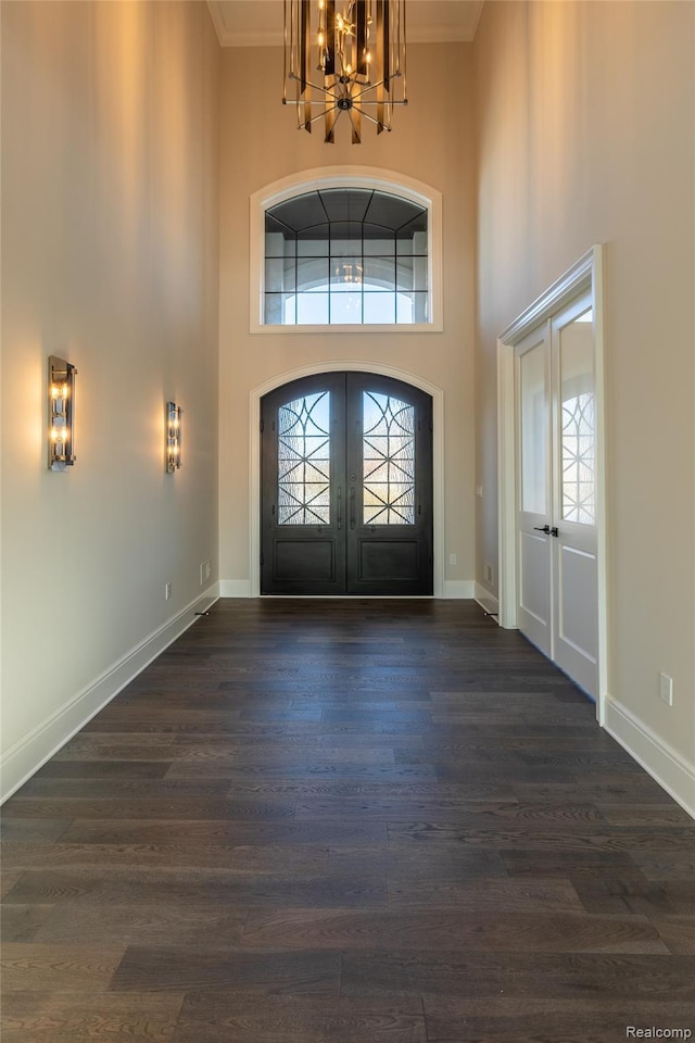 2599 Forest Glen Ct, Rochester, MI 48306 - foyer featuring french doors, a chandelier, a high ceiling, ornamental molding, and dark wood-style floors