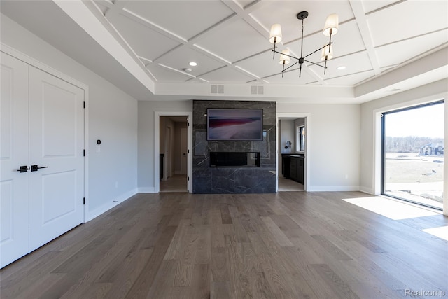 2599 Forest Glen Ct, Rochester, MI 48306 - unfurnished living room with coffered ceiling, a chandelier, wood finished floors, a premium fireplace, and recessed lighting