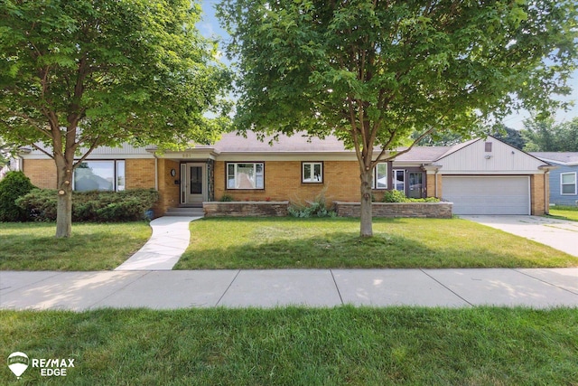 501 Lafayette St, Flint, MI 48503 - single story home with brick siding, a garage, a front yard, and driveway