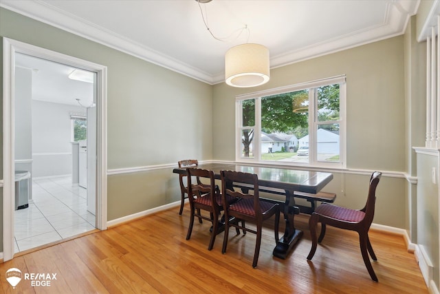 501 Lafayette St, Flint, MI 48503 - dining room with healthy amount of natural light, light wood finished floors, and crown molding