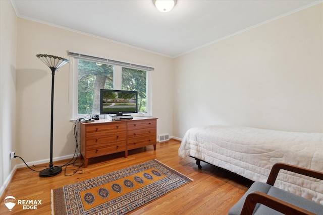 501 Lafayette St, Flint, MI 48503 - bedroom with ornamental molding and light wood-style flooring
