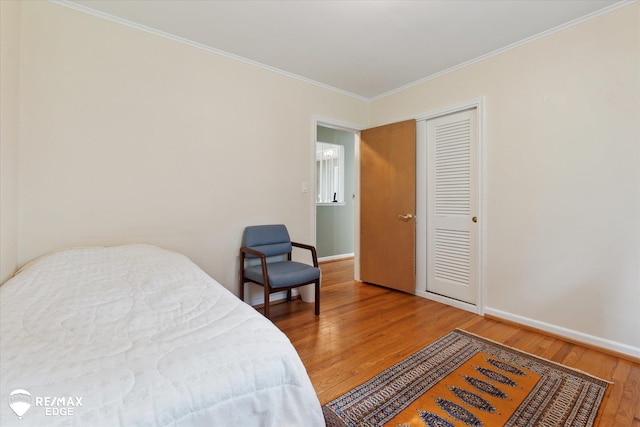 501 Lafayette St, Flint, MI 48503 - bedroom with wood finished floors, ornamental molding, and a closet