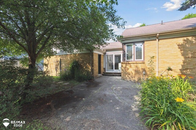 501 Lafayette St, Flint, MI 48503 - view of exterior entry with brick siding and a patio area