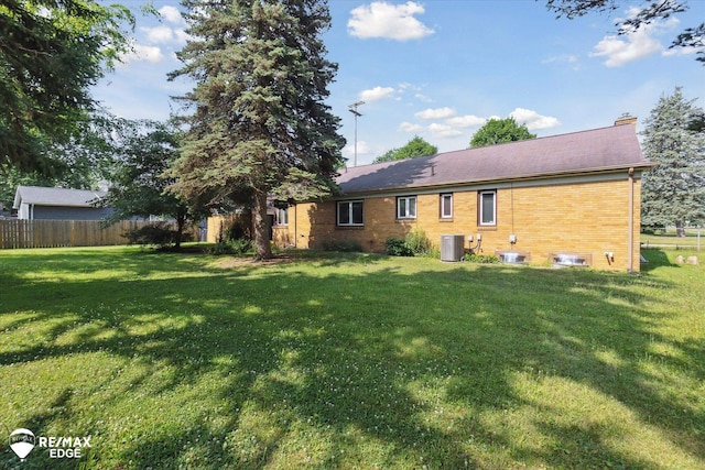501 Lafayette St, Flint, MI 48503 - rear view of house with a chimney and brick siding
