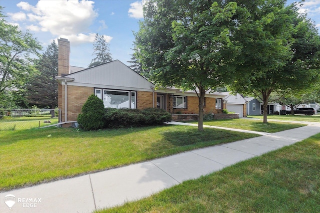 501 Lafayette St, Flint, MI 48503 - ranch-style home with a chimney, brick siding, a garage, and concrete driveway