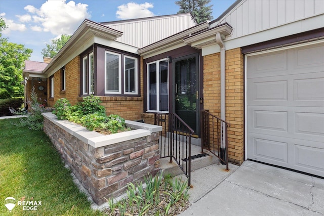 501 Lafayette St, Flint, MI 48503 - doorway to property featuring brick siding and an attached garage