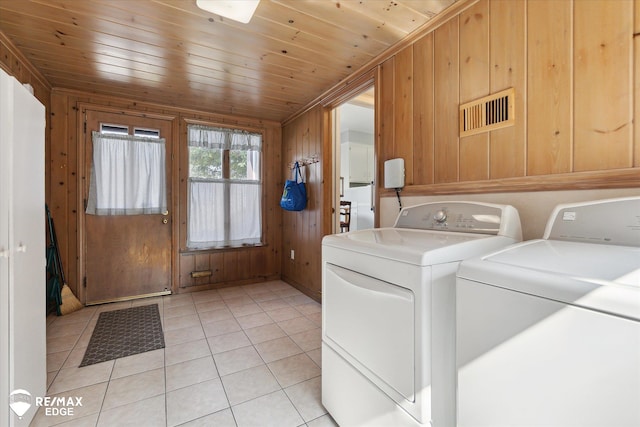 501 Lafayette St, Flint, MI 48503 - laundry room with washing machine and dryer, wooden walls, light tile patterned flooring, and wooden ceiling