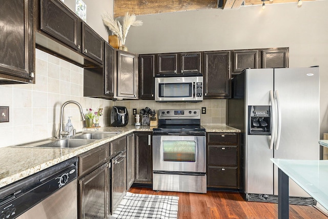 940 Monroe Ave NW Unit 416, Grand Rapids, MI 49503 - kitchen with appliances with stainless steel finishes, decorative backsplash, dark wood-style flooring, and dark brown cabinets