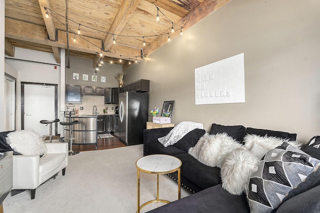 940 Monroe Ave NW Unit 416, Grand Rapids, MI 49503 - living area featuring a wood ceiling with exposed beams, rail lighting, a high ceiling, and dark colored carpet