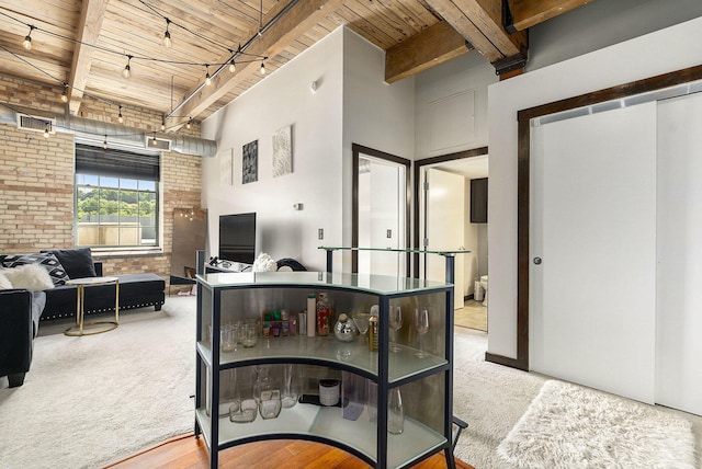 940 Monroe Ave NW Unit 416, Grand Rapids, MI 49503 - hall featuring a wood ceiling with exposed beams, carpet, and brick wall