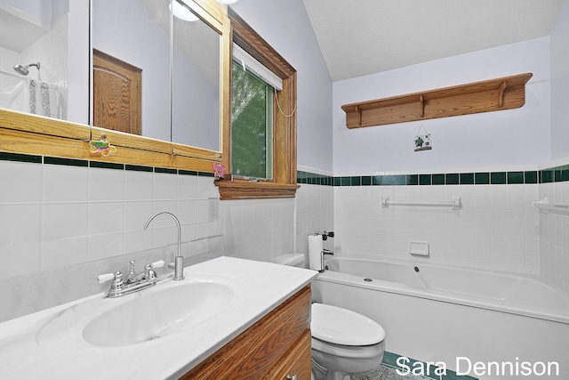 1026 Alan St, Fremont, MI 49412 - full bathroom with tile walls, a tub to relax in, vanity, and wainscoting