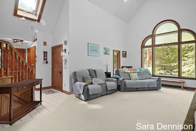 1026 Alan St, Fremont, MI 49412 - living area with high vaulted ceiling, a skylight, light tile patterned floors, and stairs