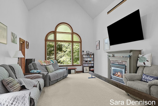 1026 Alan St, Fremont, MI 49412 - living room with high vaulted ceiling, a fireplace, and carpet