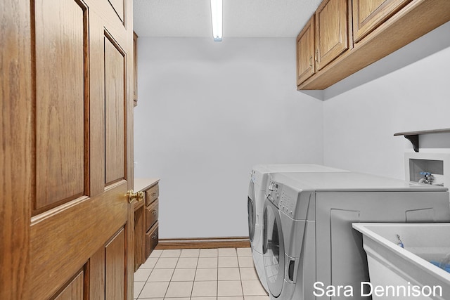 1026 Alan St, Fremont, MI 49412 - washroom featuring cabinet space, washer and dryer, light tile patterned floors, and a textured ceiling