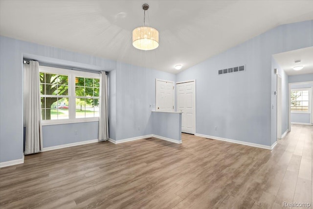 24690 Bashian Dr, Novi, MI 48375 - empty room with wood finished floors and vaulted ceiling