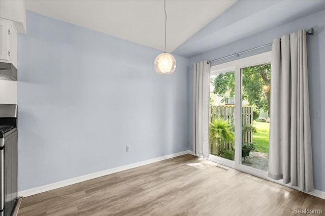 24690 Bashian Dr, Novi, MI 48375 - unfurnished dining area featuring wood finished floors and vaulted ceiling