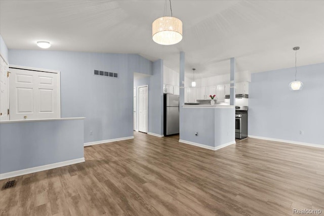 24690 Bashian Dr, Novi, MI 48375 - unfurnished living room with wood finished floors and vaulted ceiling