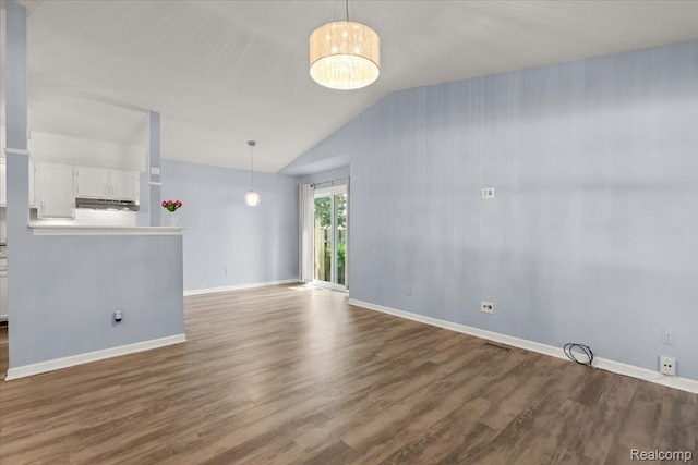 24690 Bashian Dr, Novi, MI 48375 - unfurnished living room featuring vaulted ceiling and dark wood-type flooring