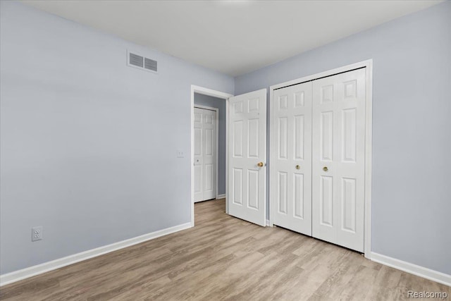 24690 Bashian Dr, Novi, MI 48375 - unfurnished bedroom with wood finished floors and a closet