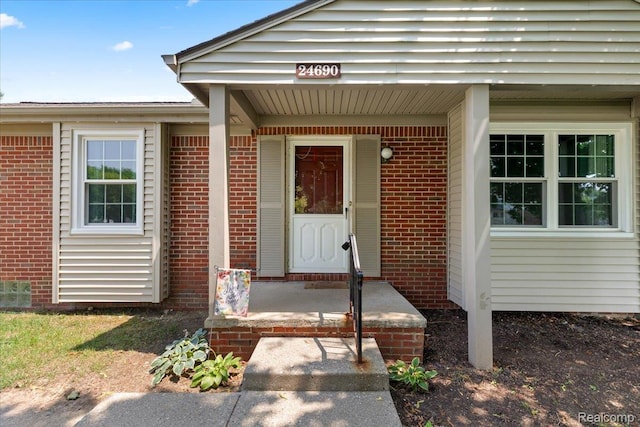 24690 Bashian Dr, Novi, MI 48375 - doorway to property featuring brick siding