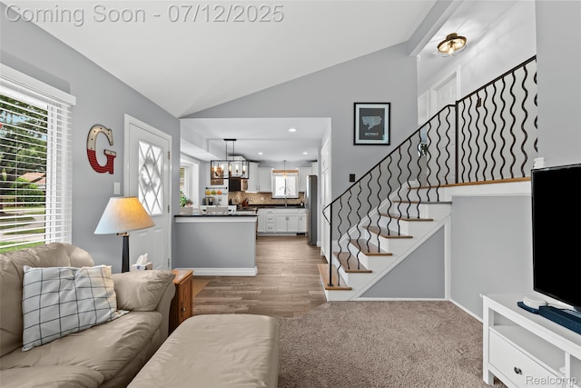 1450 N Stephen Ave, Clawson, MI 48017 - living area with stairway, a chandelier, wood finished floors, recessed lighting, and high vaulted ceiling