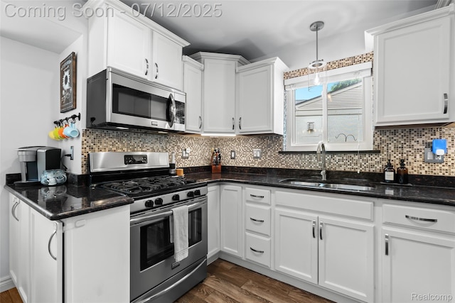 1450 N Stephen Ave, Clawson, MI 48017 - kitchen with appliances with stainless steel finishes, white cabinetry, tasteful backsplash, and dark wood-style flooring