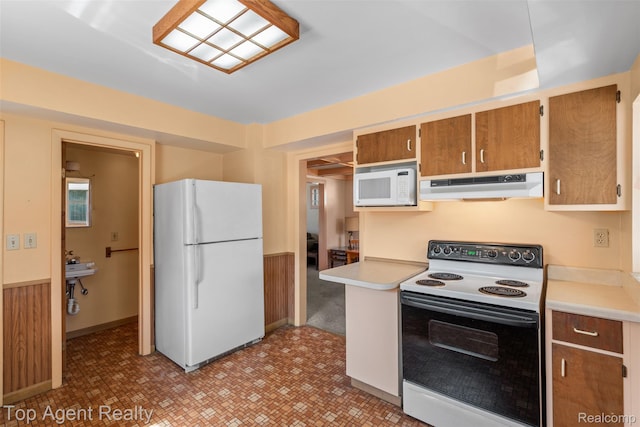 23123 E 13 Mile Rd, Saint Clair Shores, MI 48082 - kitchen with white appliances, under cabinet range hood, light countertops, and brown cabinetry