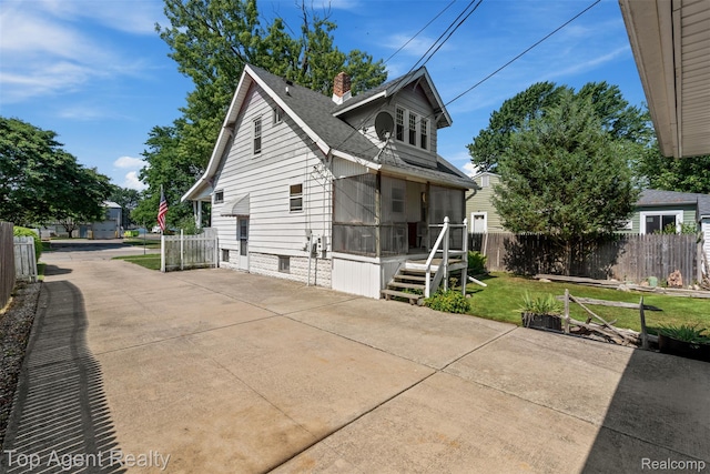 23123 E 13 Mile Rd, Saint Clair Shores, MI 48082 - view of front of home featuring a chimney, a patio area, and roof with shingles