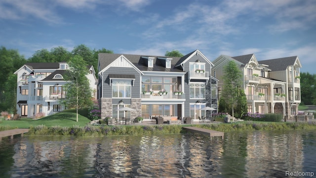 160 Darling Dr, Lake Orion, MI 48362 - back of house featuring a water view, stone siding, and a patio