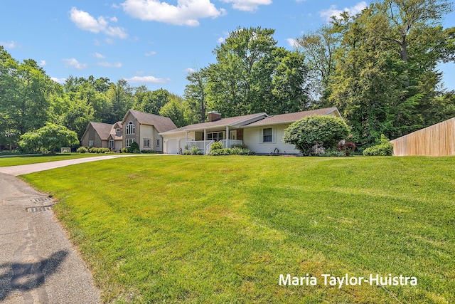 16205 Suffolk Dr, Spring Lake, MI 49456 - view of front of property with an attached garage, driveway, and a chimney